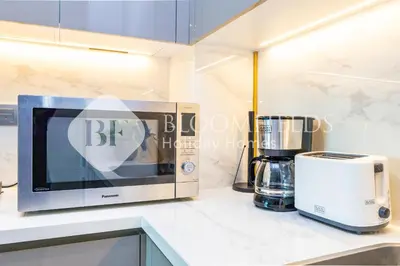a kitchen with a toaster and a blender on a counter at Bloomfields 1br Azizi Farhad Burj View Bliss in Dubai