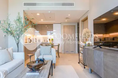 a living room with a couch and a table at Bloomfields 1br Azizi Farhad Burj View Bliss in Dubai
