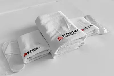 a group of white towels sitting on a table at 2-Bedroom Apartment Near To The Beach in Sadaf in Dubai