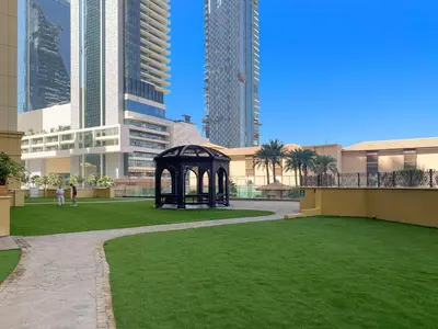 a park with a gazebo in a city with tall buildings at 2-Bedroom Apartment Near To The Beach in Sadaf in Dubai
