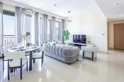 a living room with a couch and a table and chairs at Frank Porter - Harbour Views T1 in Dubai