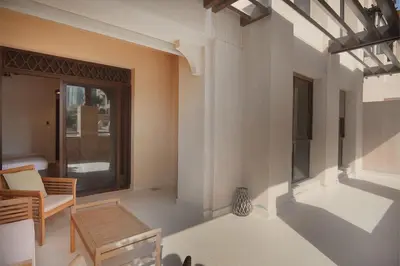 a living room with a table and a chair at EasyGo- Spacious, Authentic, City Center in Dubai