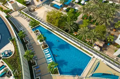 an overhead view of a swimming pool at a resort at Beachfront Bliss - Marina View - JBR The Address By ĀYA Boutique in Dubai