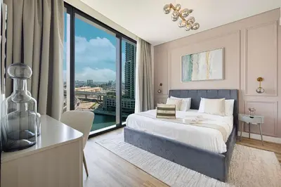 a bedroom with a bed and a large window at Beachfront Bliss - Marina View - JBR The Address By ĀYA Boutique in Dubai