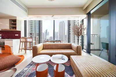 a living room with a couch and a table at PVH - 2BR Artistic Retreat in Downtown Views 2 in Dubai