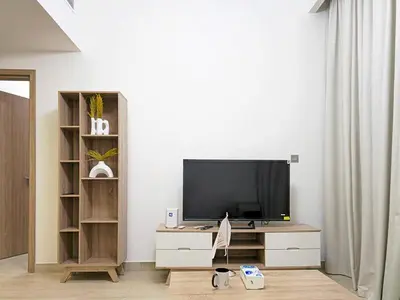 a living room with a flat screen tv on a dresser at Azizi Riviera15 - Meydan by Golden Casa in Dubai
