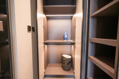 a walk in closet with a trash can in it at High Floor With Marina View in Dubai