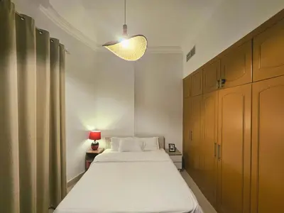 a bedroom with a white bed and a lamp at Royal Residence - Dream tower Marina in Dubai