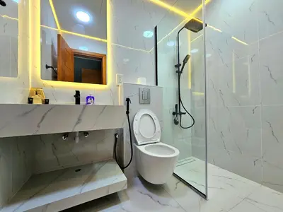 a white bathroom with a shower and a toilet at Royal Residence - Dream tower Marina in Dubai