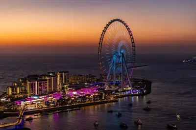 a large ferris wheel in a city at night at 2Br Panoramic sea view, Ain Dubai, Palm, JBR beach in Dubai