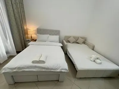 two beds in a small room with at Nice Studio On Marina Walk in Dubai