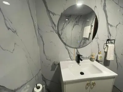 a bathroom with a sink and a mirror at Nice Studio On Marina Walk in Dubai