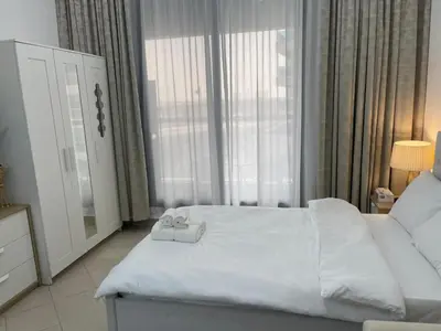 a bedroom with a white bed with two towels on it at Nice Studio On Marina Walk in Dubai