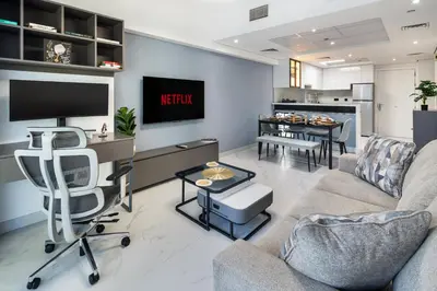 a living room with a couch and a tv at Luxury JLT 1BR Lakeview 5 min Metro & Marina in Dubai
