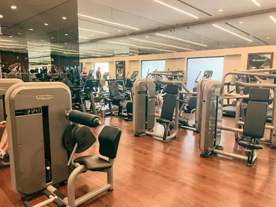 a gym with rows of treadmills and exercise equipment at Palm Jumeirah Beach Paradise at Fairmont Residence in Dubai