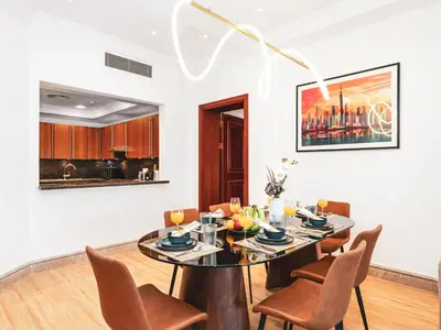a dining room with a table and chairs at Palm Jumeirah Beach Paradise at Fairmont Residence in Dubai