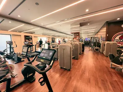 a gym with treadmills and exercise bikes in a room at Palm Jumeirah Beach Paradise at Fairmont Residence in Dubai