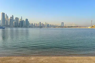 a view of a city from the shore of a body of water at Resort Style 2BR Pool Access Private Beach in Dubai