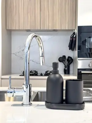 a kitchen sink with a soap dispenser on a counter at Modern & Luxury 1BR -Pool View - Kensington Waters in Dubai