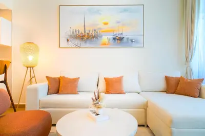a living room with a couch and a table at 3BR Marina view apartment in JBR Close to Tram & Metro in Dubai