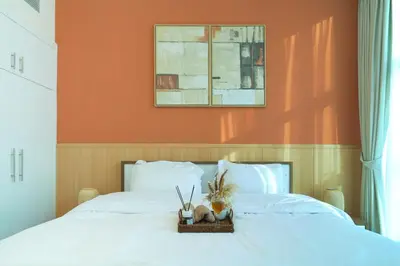 a bed with a basket of plants on it at 3BR Marina view apartment in JBR Close to Tram & Metro in Dubai