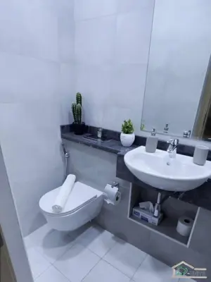 a bathroom with a sink and a toilet and a mirror at 1 BR Apartment in Downtown Dubai in Dubai