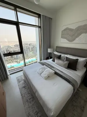 a bedroom with a large white bed with a large window at Brand new and stylish 2BR with stunning views - Creek Palace in Dubai