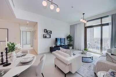 a living room with white furniture and a large window at Brand new and stylish 2BR with stunning views - Creek Palace in Dubai