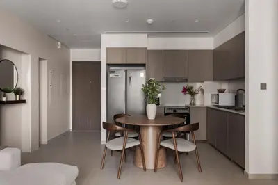 a kitchen with a table and chairs in a kitchen at Burj Khalifa View 2 BR Apartment w Parking in Dubai