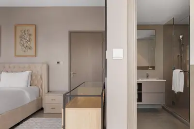 a hotel room with a bed and a bathroom at Burj Khalifa View 2 BR Apartment w Parking in Dubai
