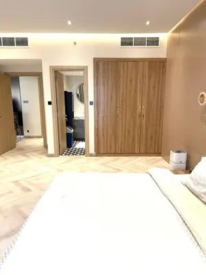 a bedroom with a large bed and a large closet at Cozy, Fully Fitted Smart Home in Dubai