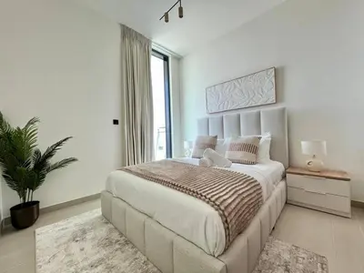 a bedroom with a large bed and a large window at Relax In Style 1br Haven In Binghatti Venus! in Dubai