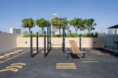 a playground with two wooden chairs in a parking lot at Relax In Style 1br Haven In Binghatti Venus! in Dubai