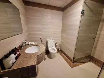 a bathroom with a toilet and a sink and a shower at ARS vacation homes rental in Dubai