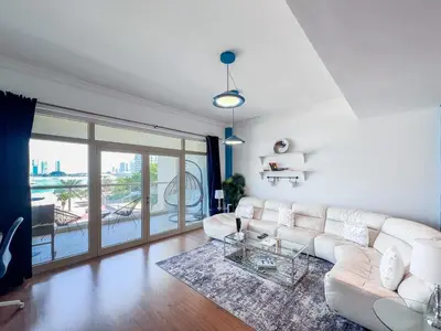 a living room with a white couch and a glass table at 1 BHK Palm Jumeirah Sea View Al Sultana Shoreline in Dubai