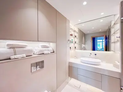 a white bathroom with a sink and a mirror at 1 BHK Palm Jumeirah Sea View Al Sultana Shoreline in Dubai