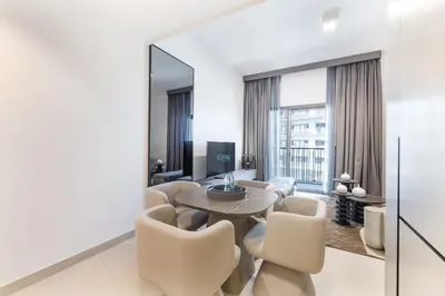 a living room with a table and chairs at ALiving Elegant 1BR Apartment with Balcony I MAG960 in Dubai