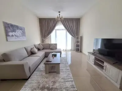 a living room with a couch and a flat screen tv at ARS vacation homes rental in Dubai