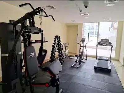 a gym with several tread machines in a room at ARS vacation homes rental in Dubai
