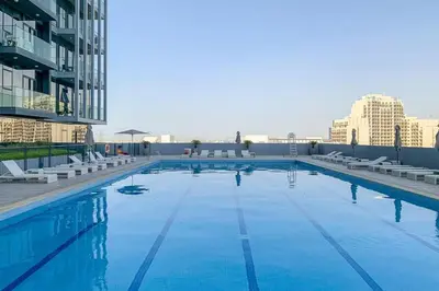 a large swimming pool on the roof of a building at Modern Fully Furnished Apartment in Bloom Tower B JVC - Easy Access to JBR, Circle Mall & Dubai Hills Mall in Dubai