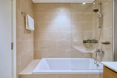 a bathroom with a tub and a shower at GuestReady - Modern design in Dubai Creek Harbour in Dubai