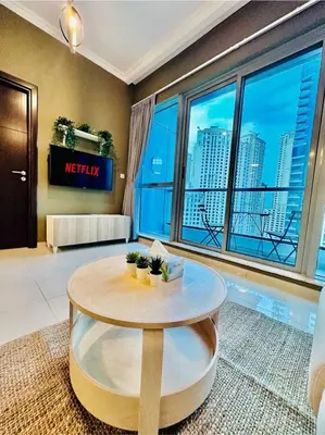 a living room with a round table and a large window at Stylish place with Breathtaking Marina Views in Dubai