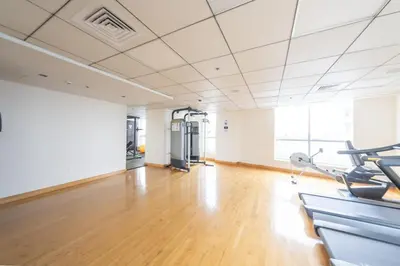 an empty room with a gym with exercise bikes at Stylish place with Breathtaking Marina Views in Dubai