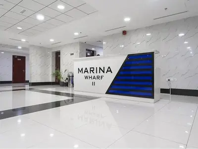 a lobby with a sign in the middle of a building at Vibrant Marina Retreat! in Dubai