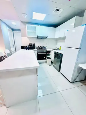 a kitchen with white appliances and a white floor at Vibrant Marina Retreat! in Dubai