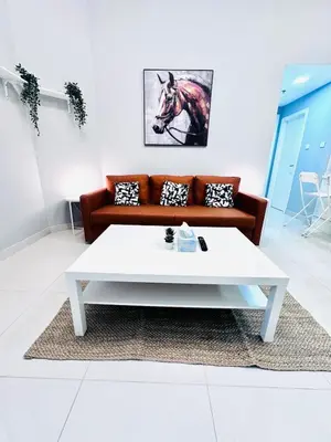 a living room with a couch and a white coffee table at Vibrant Marina Retreat! in Dubai