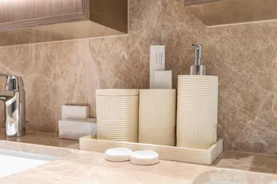 a counter with a tray with plates on it in a kitchen at Grand Bleu I Private Beach I Palm Jumeirah, Sea & Sky Views I Infinity Pool I PS5 I by Skyline Serenity in Dubai