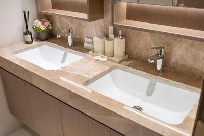 a bathroom with two sinks and two faucets at Grand Bleu I Private Beach I Palm Jumeirah, Sea & Sky Views I Infinity Pool I PS5 I by Skyline Serenity in Dubai
