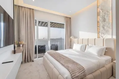 a bedroom with a large bed and a large window at Grand Bleu I Private Beach I Palm Jumeirah, Sea & Sky Views I Infinity Pool I PS5 I by Skyline Serenity in Dubai