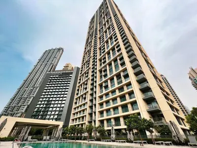 a tall building with a pool in front of it at Lux apartment with full Burj View - 5 min walk to Dubai Mall in Dubai